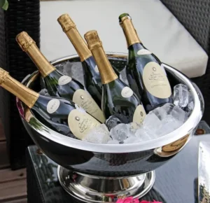 A silver bowl containing six bottles of champagne, elegantly arranged for a celebratory occasion.