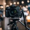 A camera mounted on a tripod positioned in a well-lit room, ready for photography or videography.